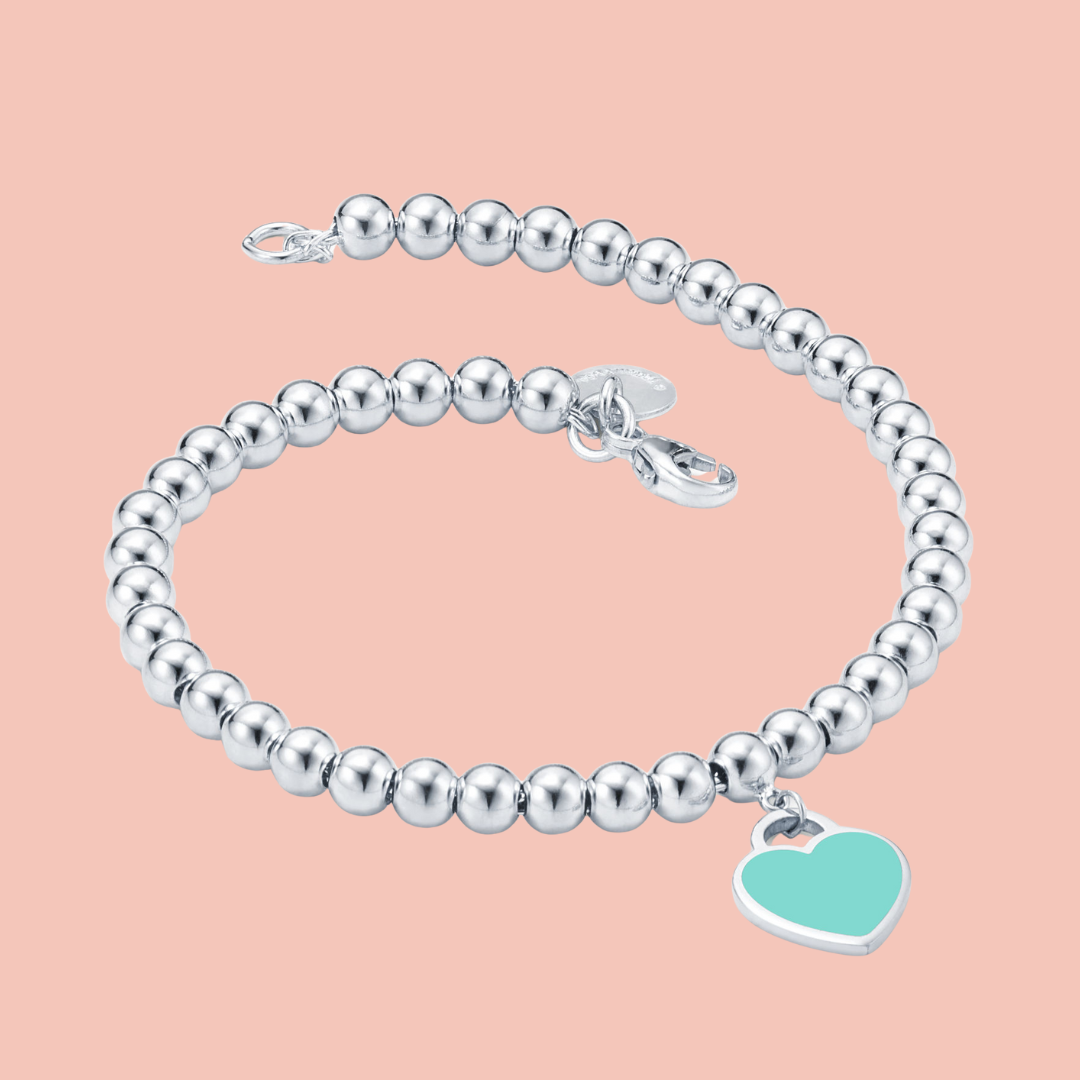 Pulsera plata con bolitas y corazón verde