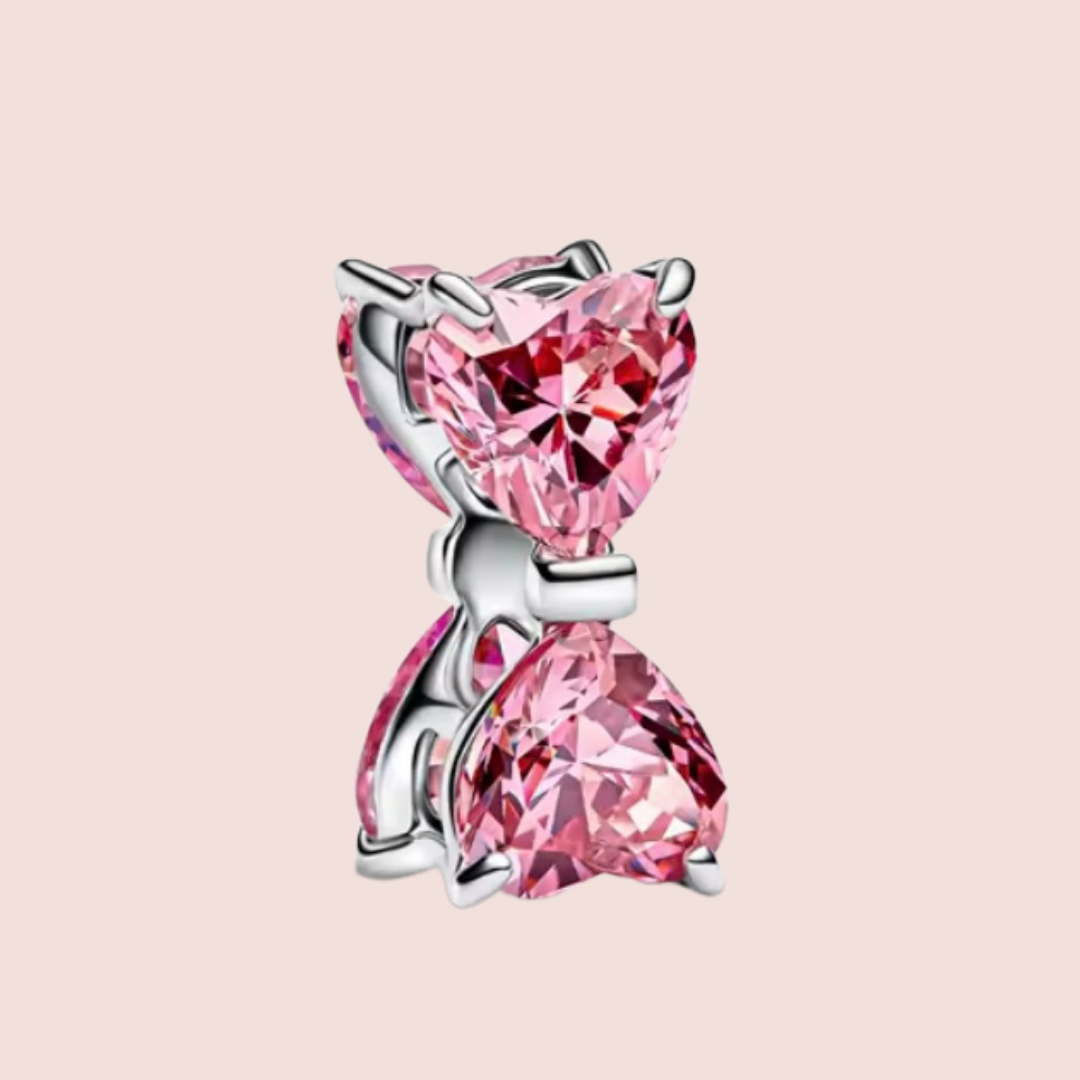 Charm moño plata con piedras rosas