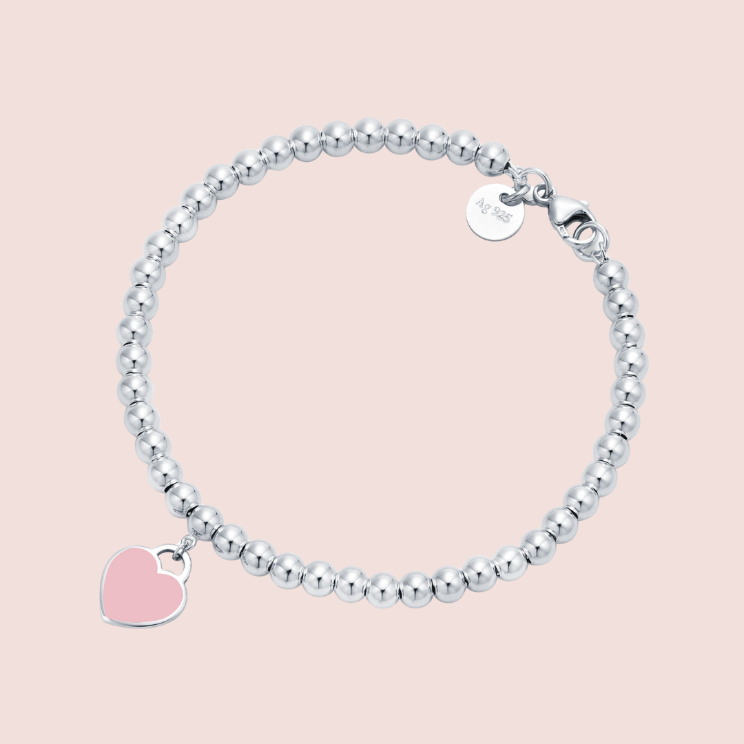 Pulsera plata con bolitas y corazón rosa