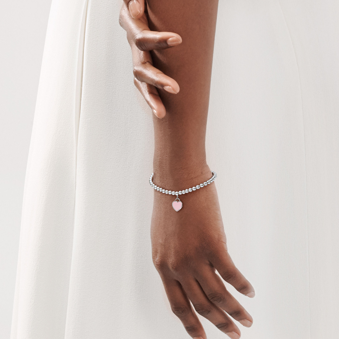 Pulsera plata con bolitas y corazón rosa