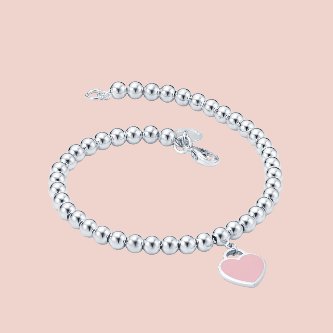Pulsera plata con bolitas y corazón rosa