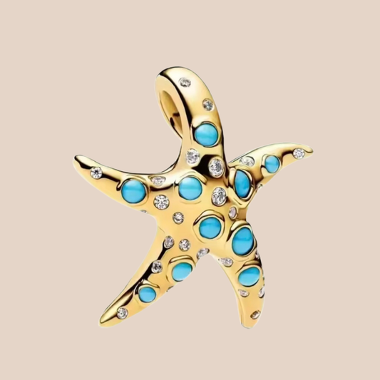 Charm estrella de mar dorada grande con piedras azules