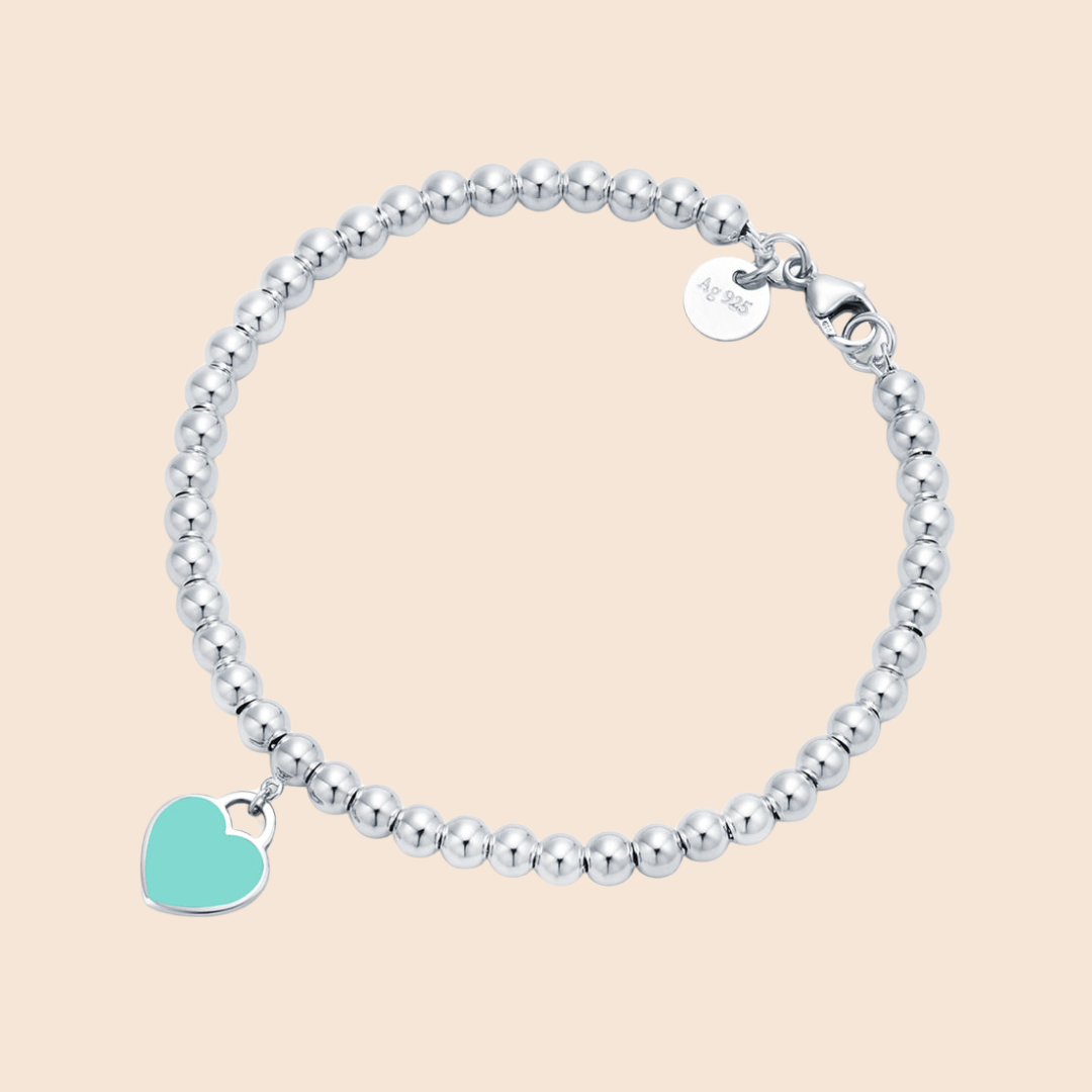 Pulsera plata con bolitas y corazón verde