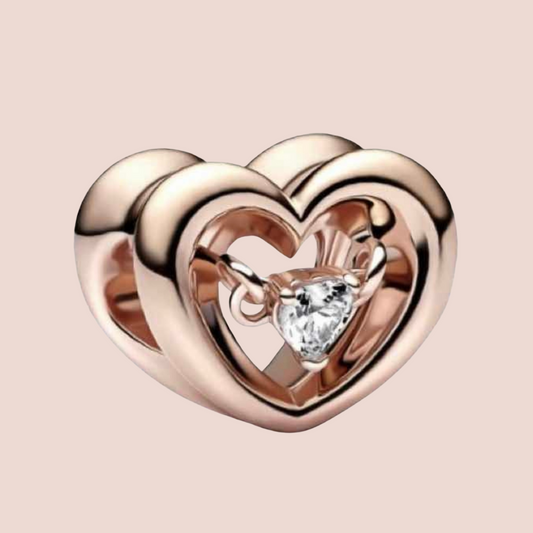 Charm corazón oro rosa con piedra plata en el centro